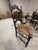 Vintage (likely antique) wood ladder chair with straw seat.