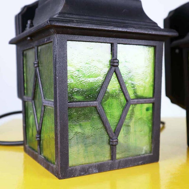 Item : Pair of metal wall lights with hand-crafted colored glass, with a classic, decorative feel. The sturdy structure...