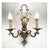 A pair of silver- and gold-plated iron wall sconces, ideal for illuminating any classic decor, are crafted from forged and...