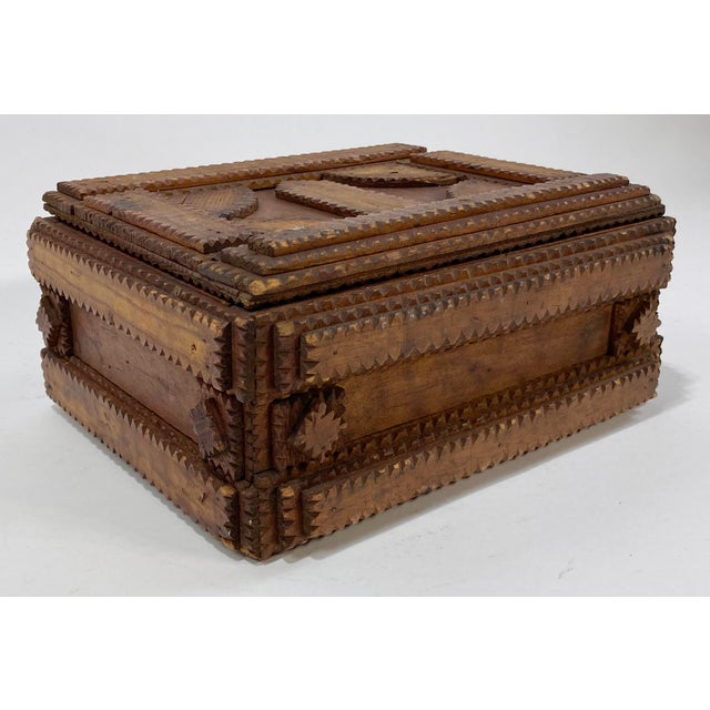 Large early 20th century tramp art box made from solid wood. In the typical fashion of tramp art, geometric shapes are...
