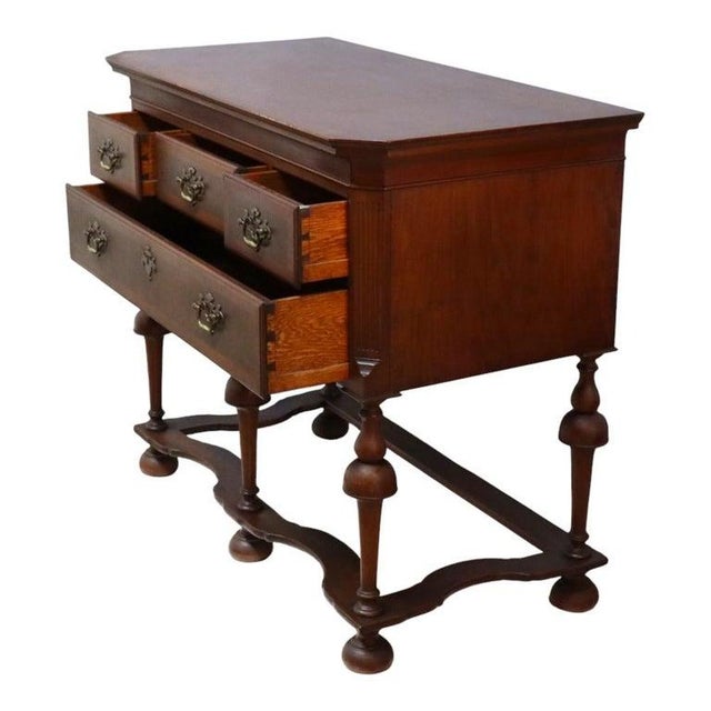 This antique Queen Anne style server, dating to approximately 1930, is crafted from banded mahogany. The server features a...