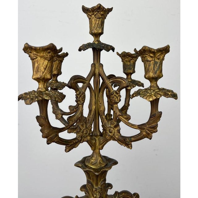 An impressive Antique French brass candelabra featuring five arms, elaborate scrolling forms and richly detailed floral...