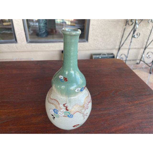 Chinese porcelain huluping dragon vase, clawed dragons cavorting amid stylized clouds, meander and Ru Yi border at the...