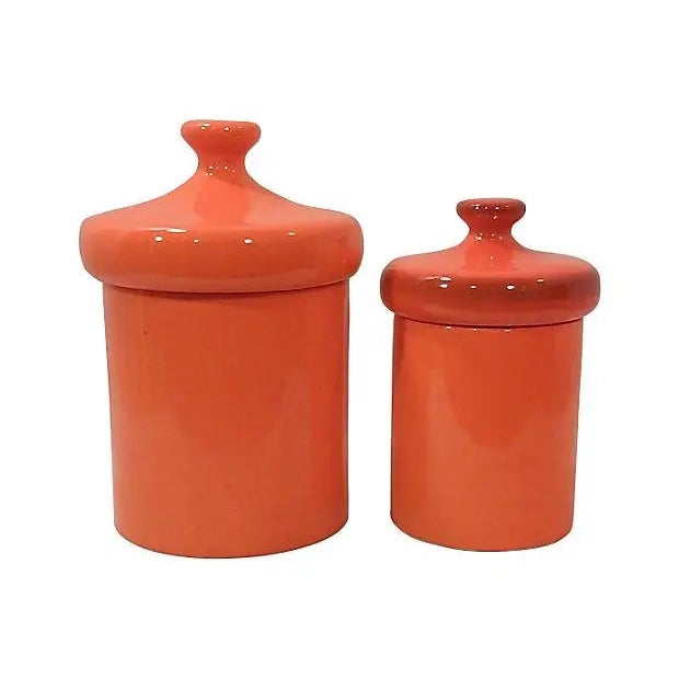 Mid-Century orange canisters in ceramic with a slightly speckled finish. The vintage canisters are a large size and in...