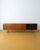 A 1960s Danish teak sideboard, 240 cm long—a dramatic piece, designed to discreetly and elegantly occupy an entire wall....