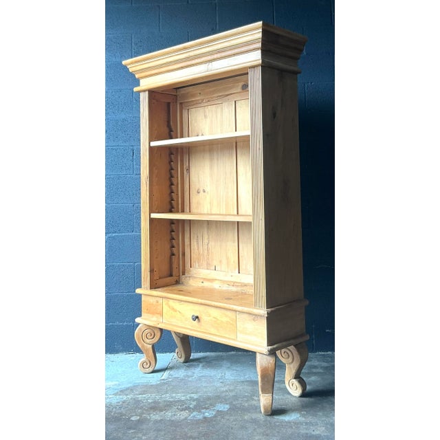 This commanding etagere or display cabinet offers a sophisticated blend of traditional architectural detailing and rustic...