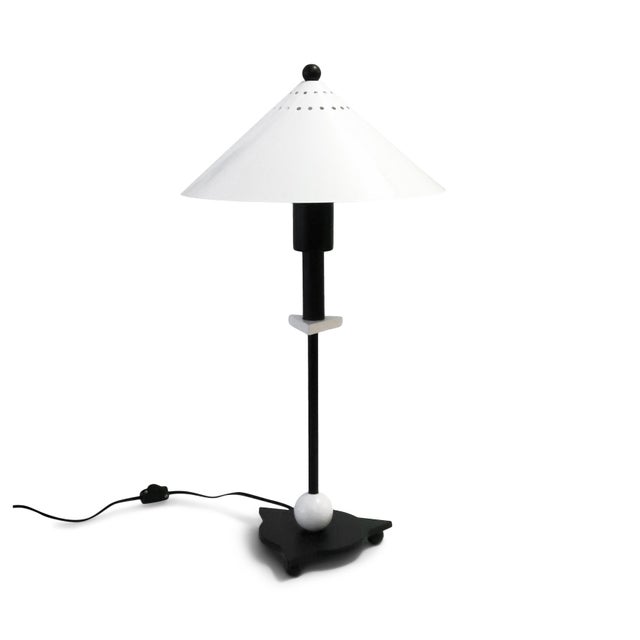 A stunning 1980s postmodern table lamp by Be Yang in the Memphis Milano style. A black metal base, black stem with white...