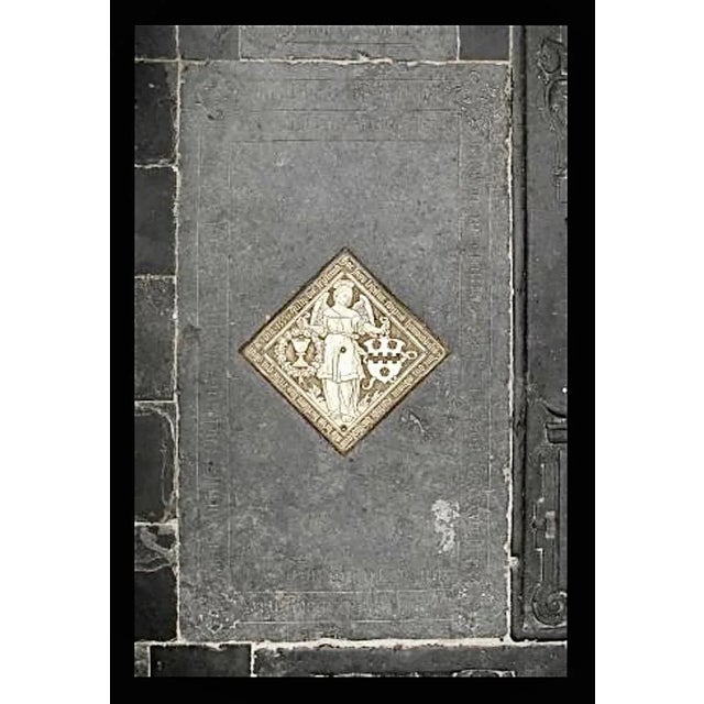 This is an engraving of a tomb monument rubbing that has been highlighted with gold color on a dark grey to black...