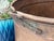 Huge Antique Copper Cauldron: Hand Forged Firewood Bucket 19" With Hand Etched Riveted Handle Green Patina Damage For Sale - Image 4 of 14