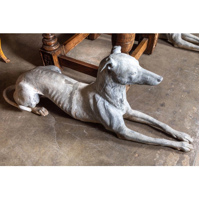 Absolutely chic pair of detailed, left and right, hand-cast, French, lead and zinc, recumbent greyhounds from the early...