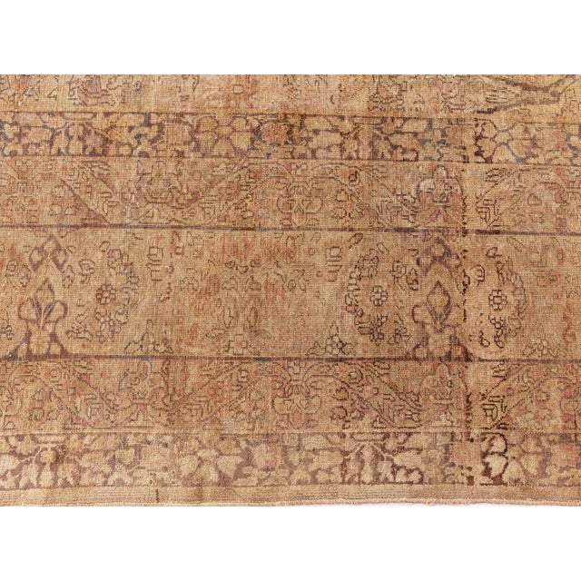 A late 19th century Persian Kerman rug, the maize field with an allover curvilinear design of floral motifs, vines and...