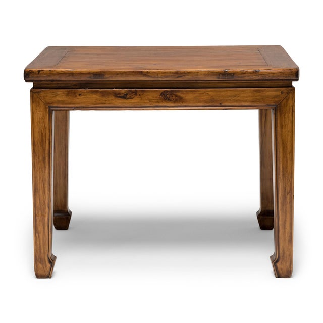 With swirling grain and warm coloring, the subtle beauty of peach wood stars in this low side table from China's Shanxi...