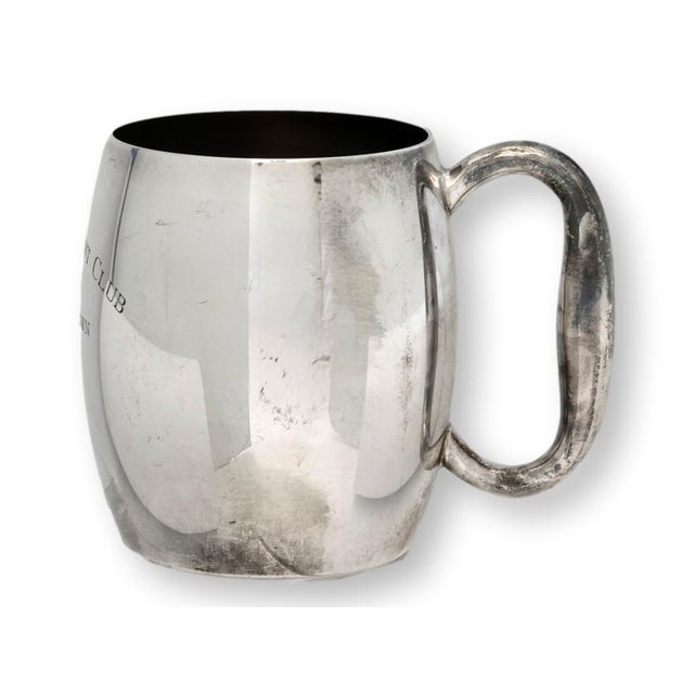Silverplate trophy mug from the Johore Yacht Club, engraved “Won by H. H. Brown.” This handsome cup reflects the glamour...