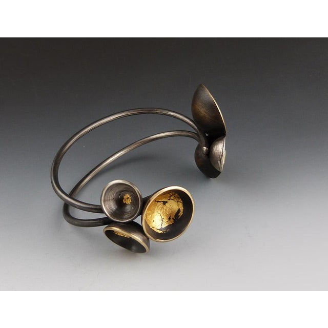 This handmade cuff bracelet by Emily Hunziker Phillips, Fulcrum Jewelry Studio, dazzles with contrasting 24k gold leaf on...