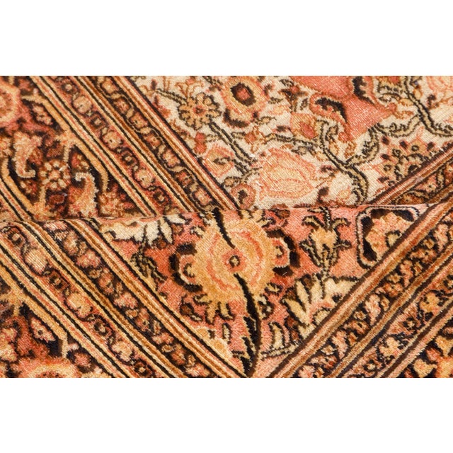 A Persian Khorassan rug, the ivory field with staggered cypresses and decorative vases as part of an allover trellis of...