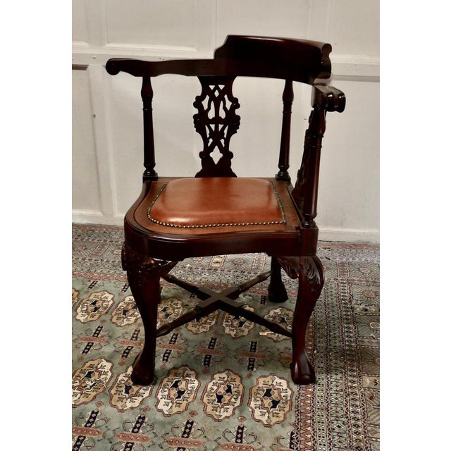A Chunky Georgian style mahogany corner arm chair A good heavy chair with a studded tan leather seat, on the back the...