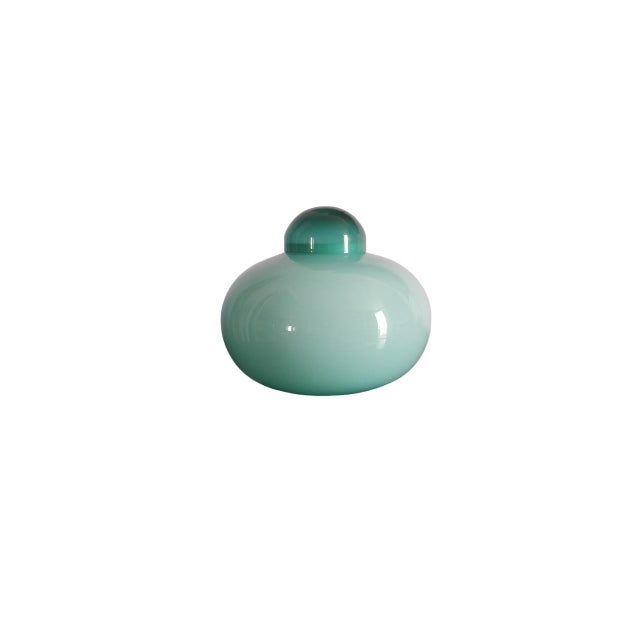 This vase is an elegant green glass work, round in shape with a diameter of 25 cm and a height of 24 cm. The choice of...