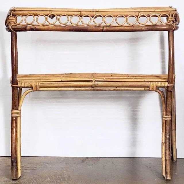 A fine Italian drinks bar for cocktails or console serving table of rattan, bamboo, and woven cane, featuring two tiers on...