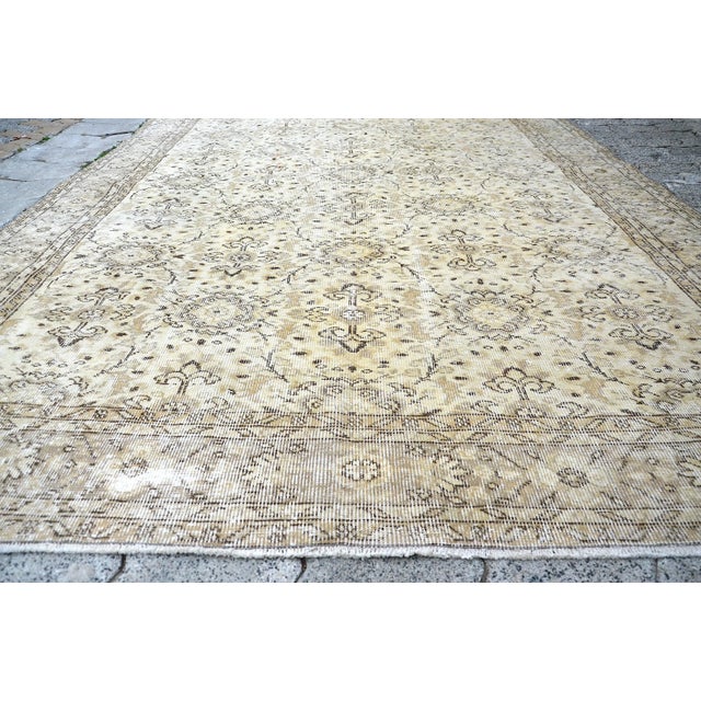 This is a vintage Turkish Oushak rug from the 1960s. The piece was hand-knotted.