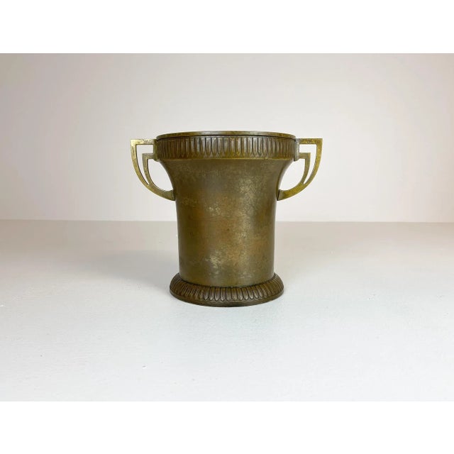 This champagne cooler is made in copper and brass. The piece has a genuinely nice relief pattern and is crafted by hand....