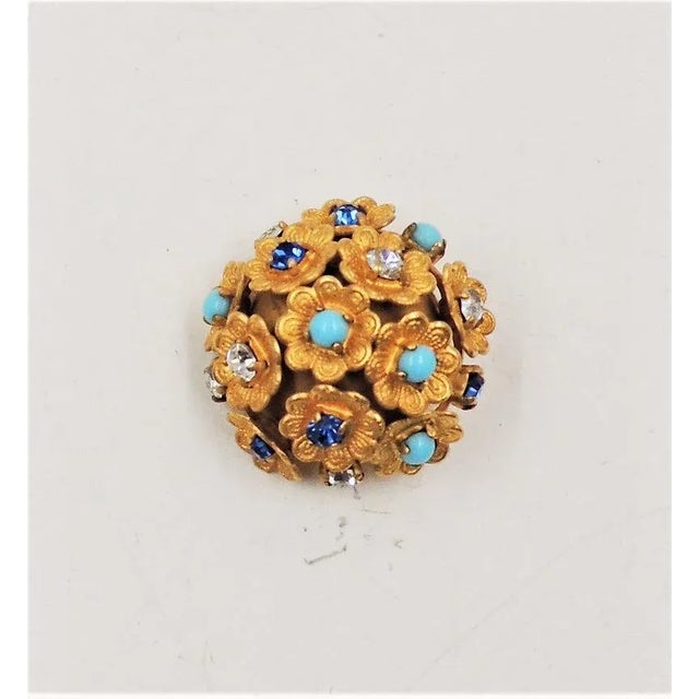 This is part of Chairish’s Costume Jewelry assortment. Circa 1960s goldtone round domed textured flowers with cabochon...