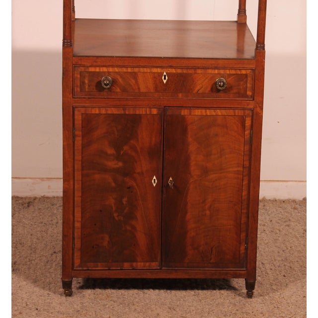 Stunning mahogany shelf unit, known as "whatnot," composed of three shelves, three drawers, and two doors at the bottom....