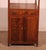 Stunning mahogany shelf unit, known as "whatnot," composed of three shelves, three drawers, and two doors at the bottom....