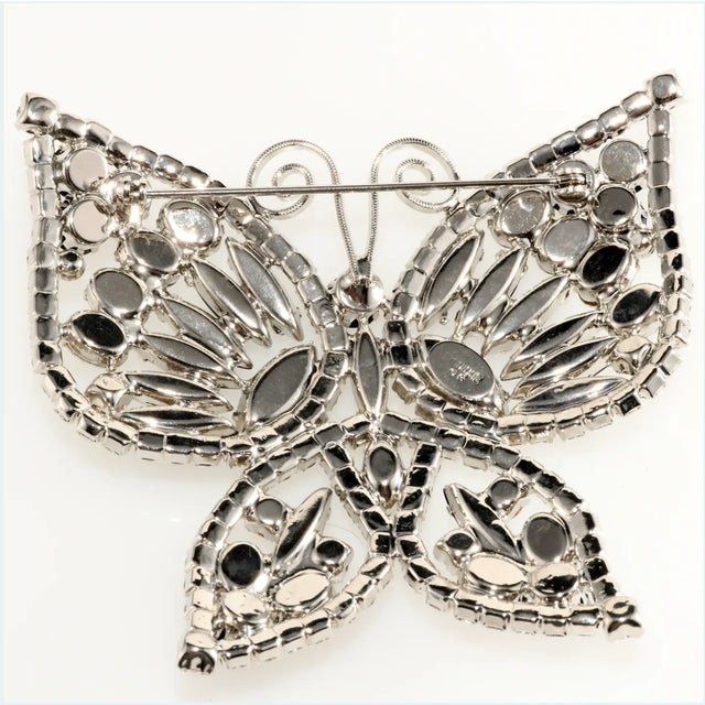 Large butterfly brooch decorated with black and clear rhinestones in a pattern that provides a hint of Art Deco revival...