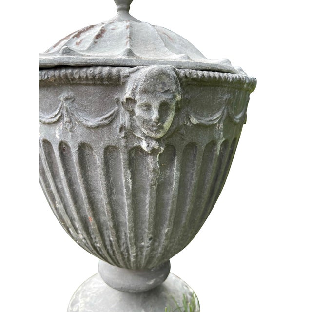A pair of large antique 19th century English Regency period lead garden urns & covers. Each with fluted vase form body,...