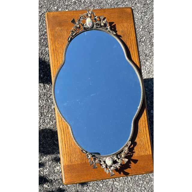 Gold Gilt Vanity Dresser Mirror with Birds on each end of the Handles surrounding Gem with Flowers on it .
