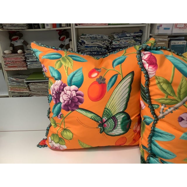 Pair of 22" X 22" Orange Botanical Manual Canovas down filled pillows with beaded trim.