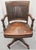 A 1900s Sikes Furniture Company Walnut and Leather Upholstered Seat and back rolling desk chair. Swivels and tilts. Firm...