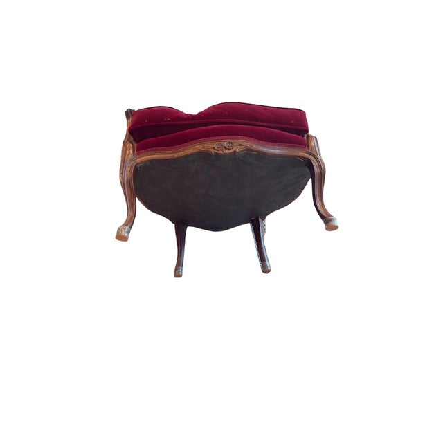 Elegant pair of antique Victorian parlor chairs featuring finely carved wood frames and rich burgundy velvet upholstery....