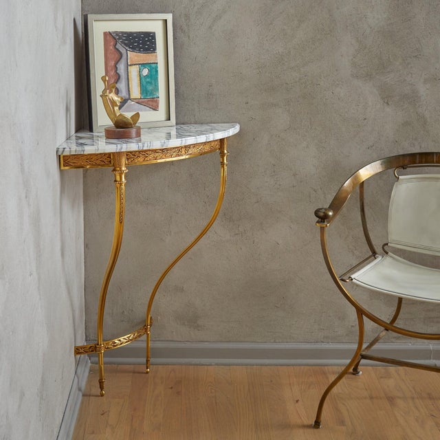 Sold and priced individually. This 1950s French corner console seamlessly blends ornate detailing with elegant...