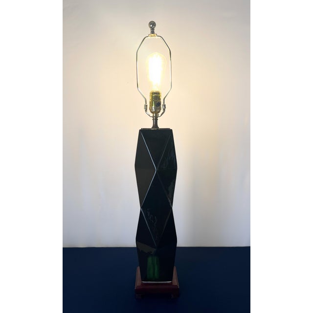 This architectural statement piece functions as a high-relief sculpture, utilizing sharp, multi-faceted planes to create a...