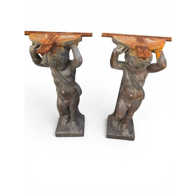 Exceptional pair of bronze console supports sculpted in the form of two putti, combining architectural function with...