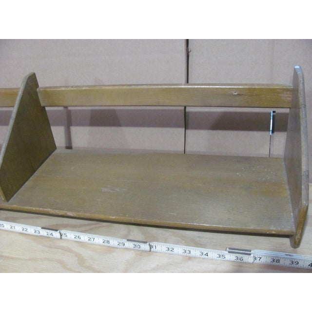 Floating bookshelf or display shelf attributed to Hans J. Wegner for RY Mobler. The solid wood, hanging shelf is 39.5"...