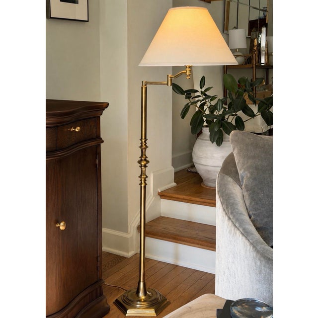 Vintage Stiffel floor lamp crafted in solid brass with a substantial weighted base, turned architectural detailing, and an...