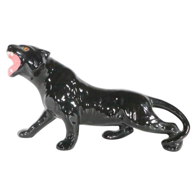 Striking ceramic black panther statue, with menacing open mouth with exposed teeth, and glittering glass eyes. This...