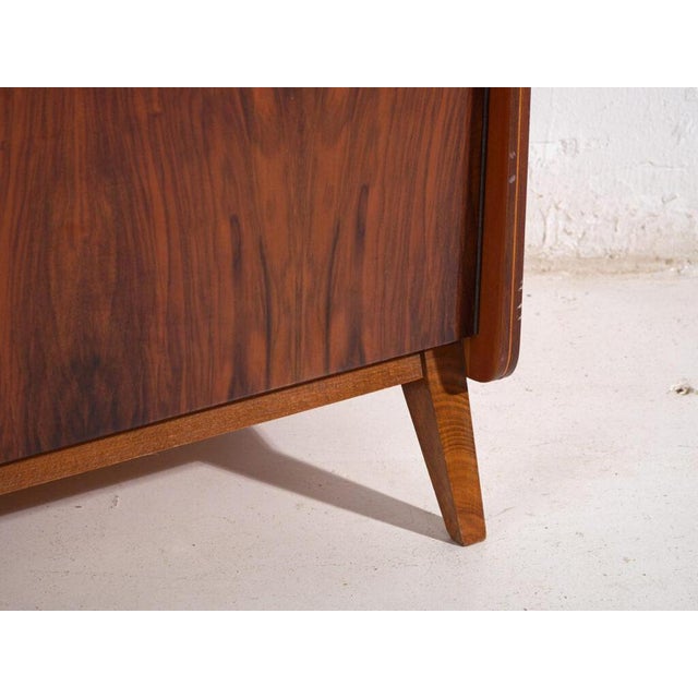 Mid-century rosewood veneer wardrobe, produced in Czechoslovakia and attributed to Závody Pravánec, circa 1950s.In the...