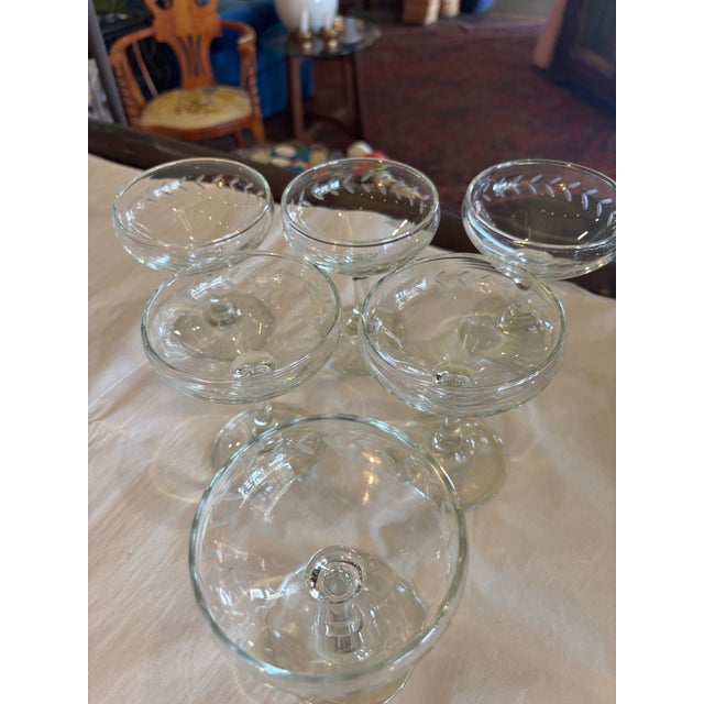 darling etched glass champagne coupes with etched "laurel" style leaf motif around the rim. Excellent vintage condition.
