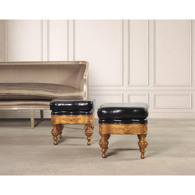 A dramatic pair of foot stools or ottomans crafted in the Napoleonic Empire or Aesthetic Movement style. The stools...