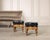 A dramatic pair of foot stools or ottomans crafted in the Napoleonic Empire or Aesthetic Movement style. The stools...