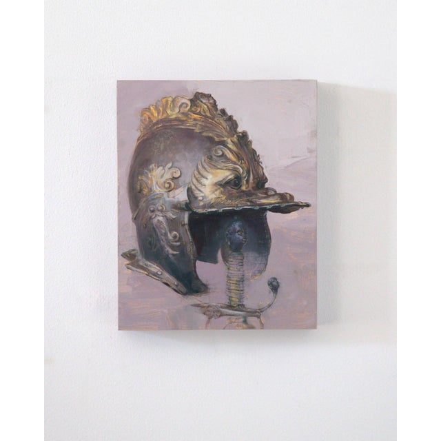 This artwork features an intricately detailed helmet, adorned with ornate embellishments, set against a soft, muted...