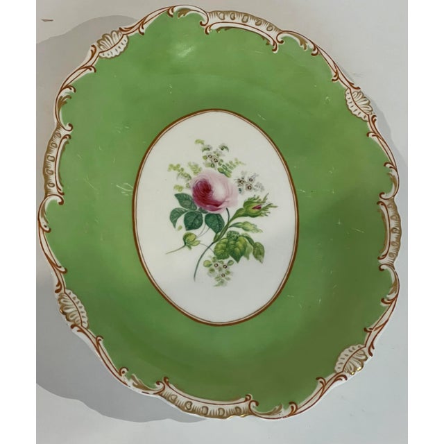 Old Paris porcelainpedestal dish with hand painted rose in the center and accents of gold building. Beautiful band of...