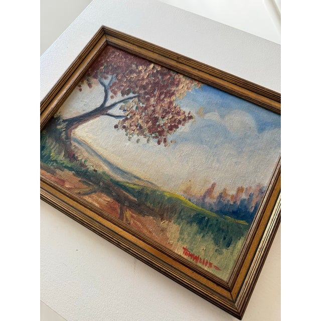 Signed, early mid-century American landscape depicting a tree with colored leaves arching over a country road with rolling...