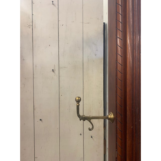 Oversized antique Victorian walnut pier hall mirror. Carved detail setback bench with marble seat, brass hooks on sides of...