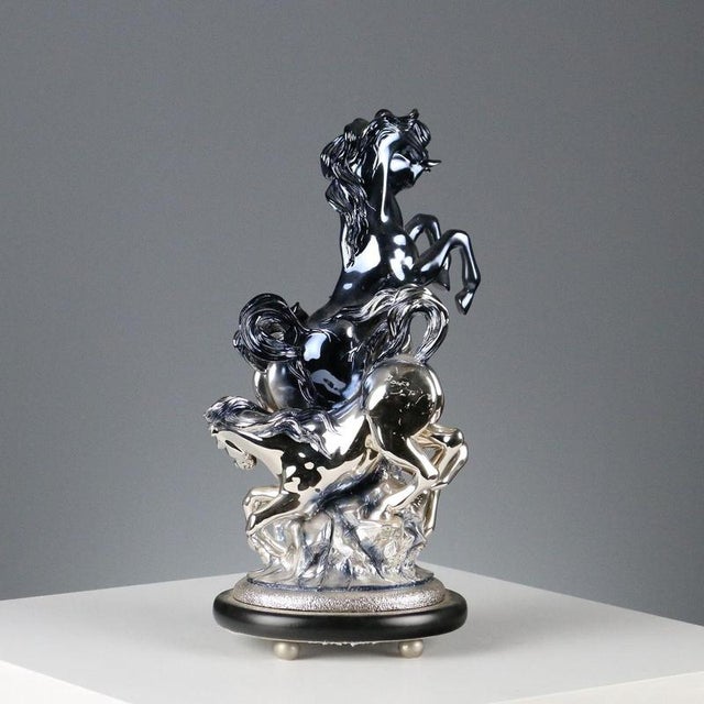 Silver-plated resin sculpture depicting horses. Manufacturer's mark engraved on the base. This piece is attributed to the...