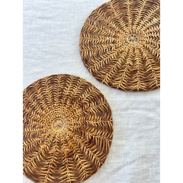 Beautiful pair of vintage pine needle trivets. One is slightly larger than the other at 7 inches and 7.5 inches in...