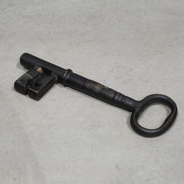 ABOUT A vintage brass and wrought iron skeleton key. Embossed "PENN" on the side. Shown with lifesize hand model for...